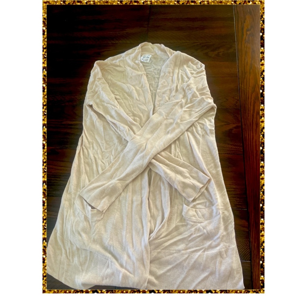 Cream color cardigan. A little longer than the usual cardigan.